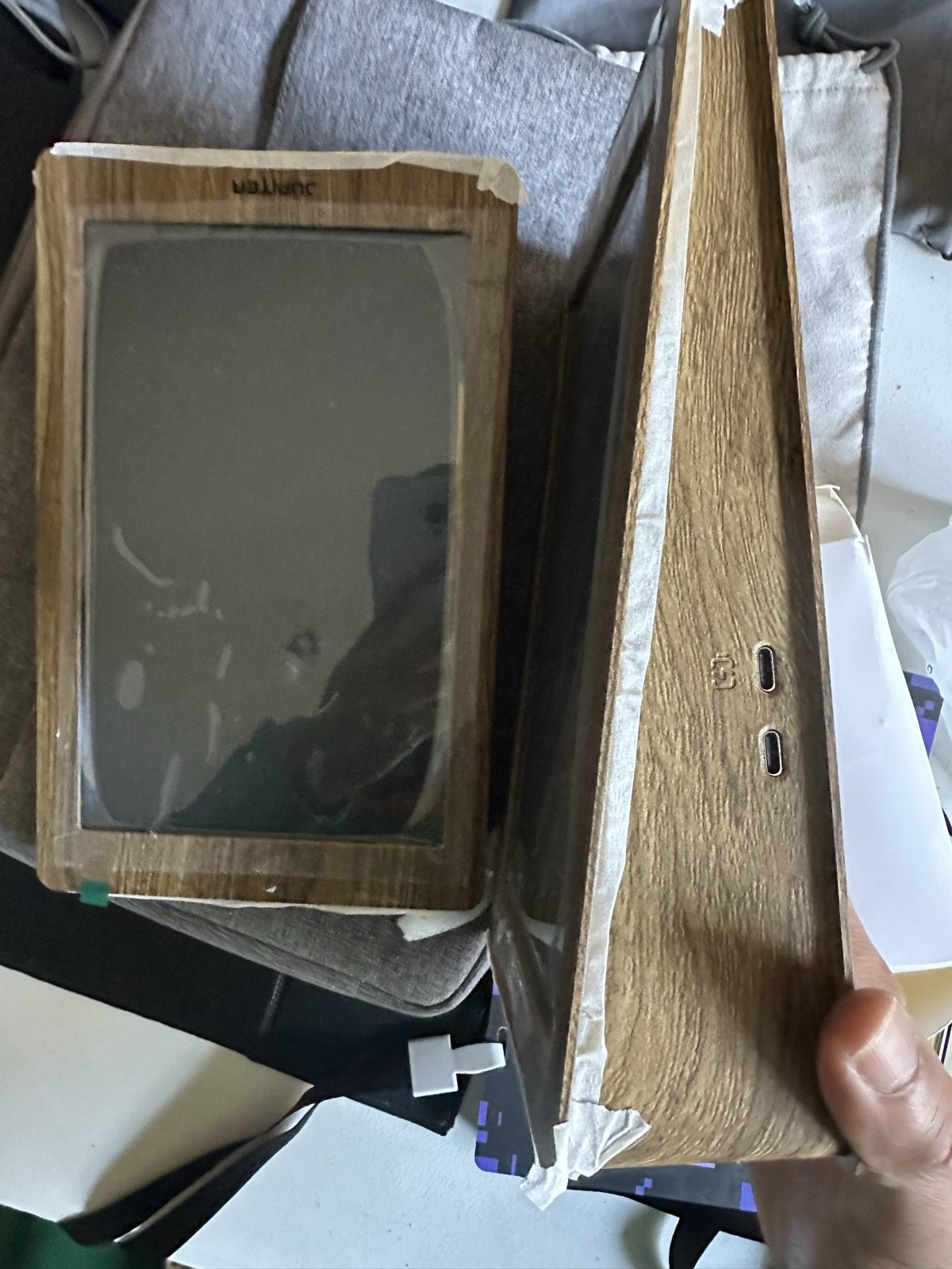 The wood-grain frame just unpacked, with USB-C ports on the side.